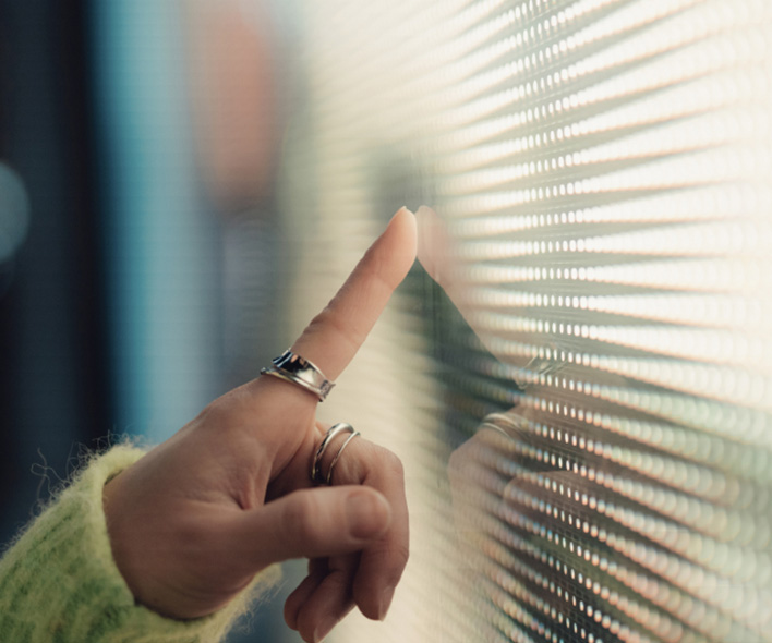 woman's finger touching a digital screen